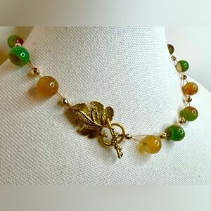 Green peacock 12 mm agate floating necklace with gold tone grape leaf toggle